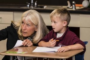 Logos Academy teacher and student looking at something