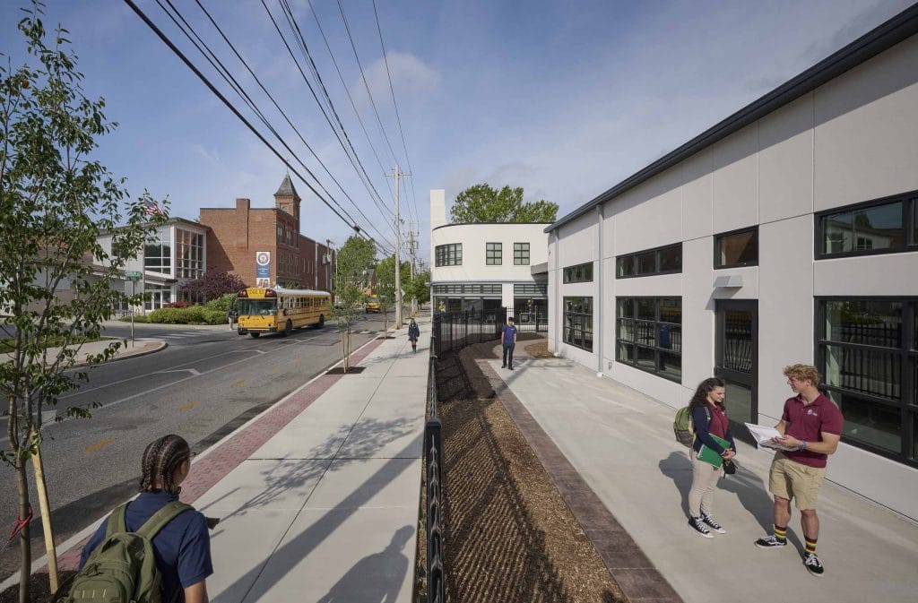 Logos Academy students walking past new campus building